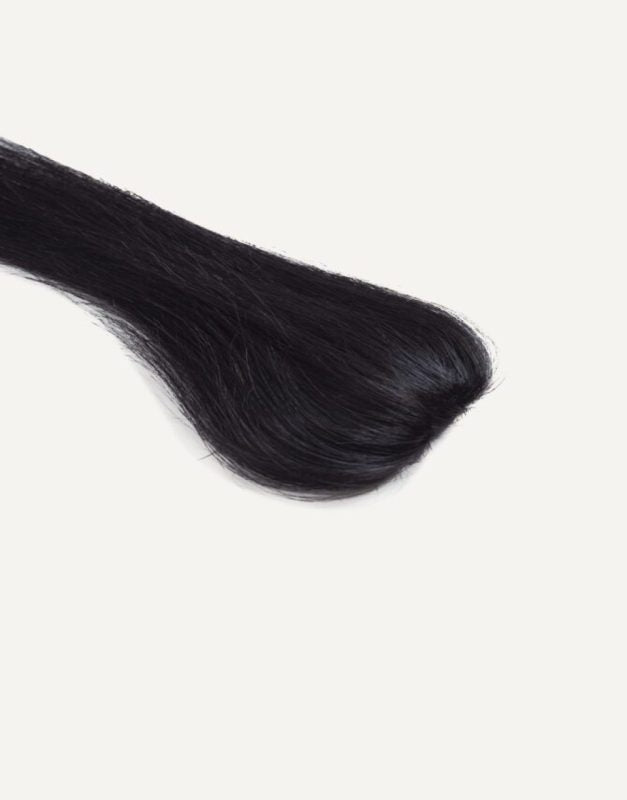 Dolcy Invisible 1 Clip Hair Patch in Jet Black – Product Flat Lay Top View Showing Natural Patch Shape and Seamless Invisible Base Made from 100% Remy Human Hair