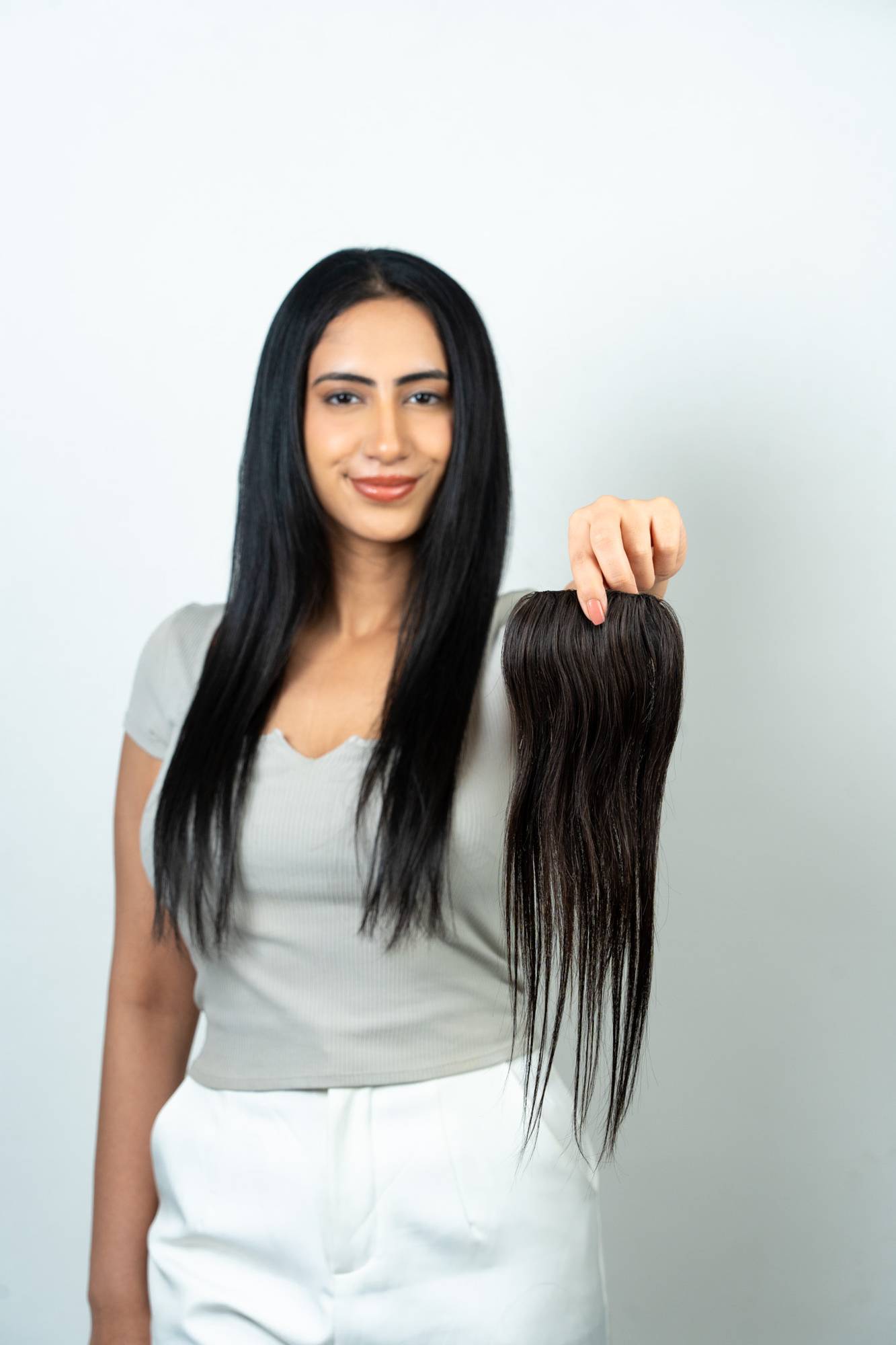 Model Holding Dolcy Invisible Push Up Hair Patch – Base Side View Showing Natural Skin-Like Invisible Scalp Base for Undetectable Blend with 100% Remy Human Hair