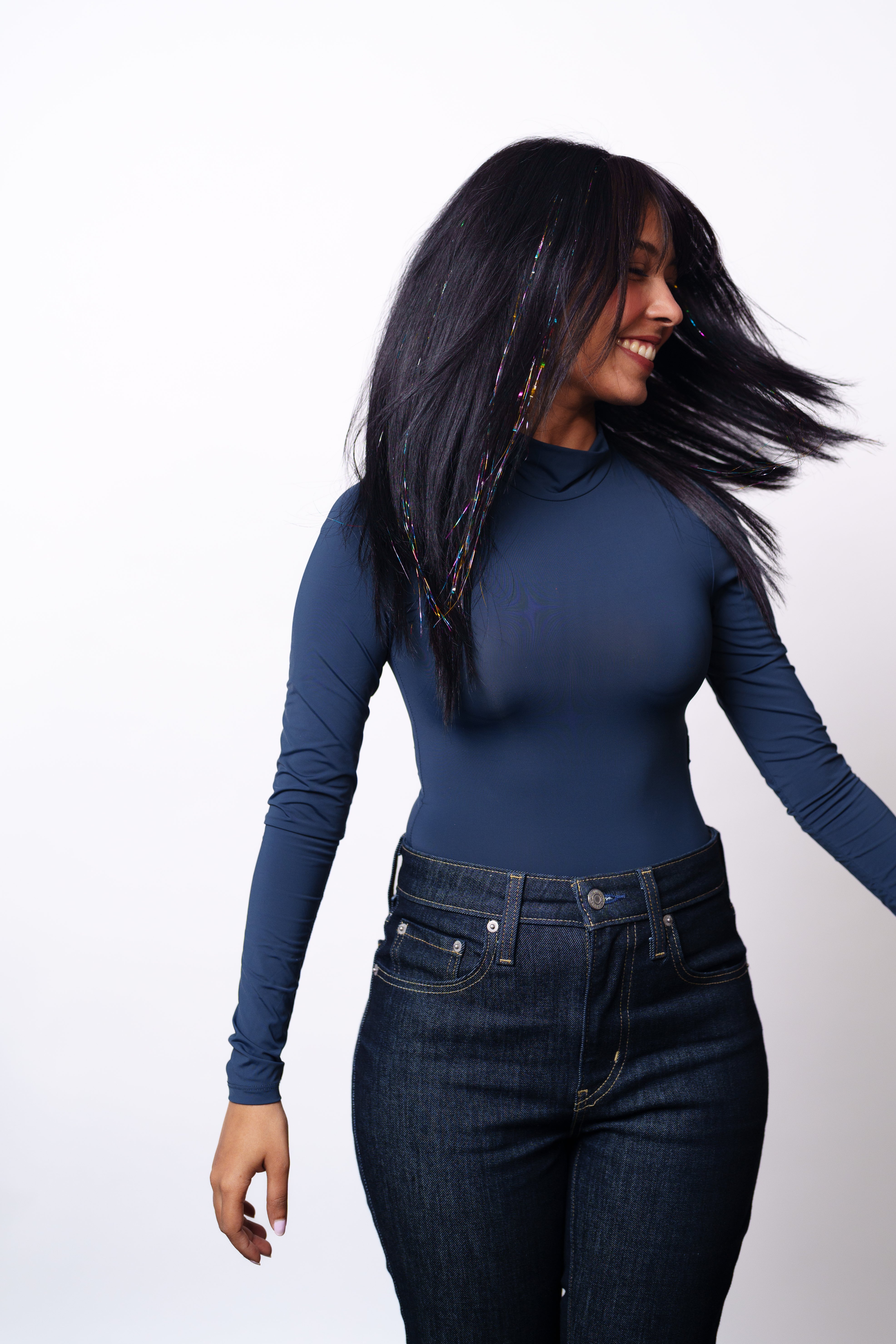 Model Wearing Dolcy Rainbow Glitter Clip-In Hair Tinsel – Front Portrait View Showing Vibrant Multicolour Sparkle Tinsel Strands Catching Light in Natural Dark Hair