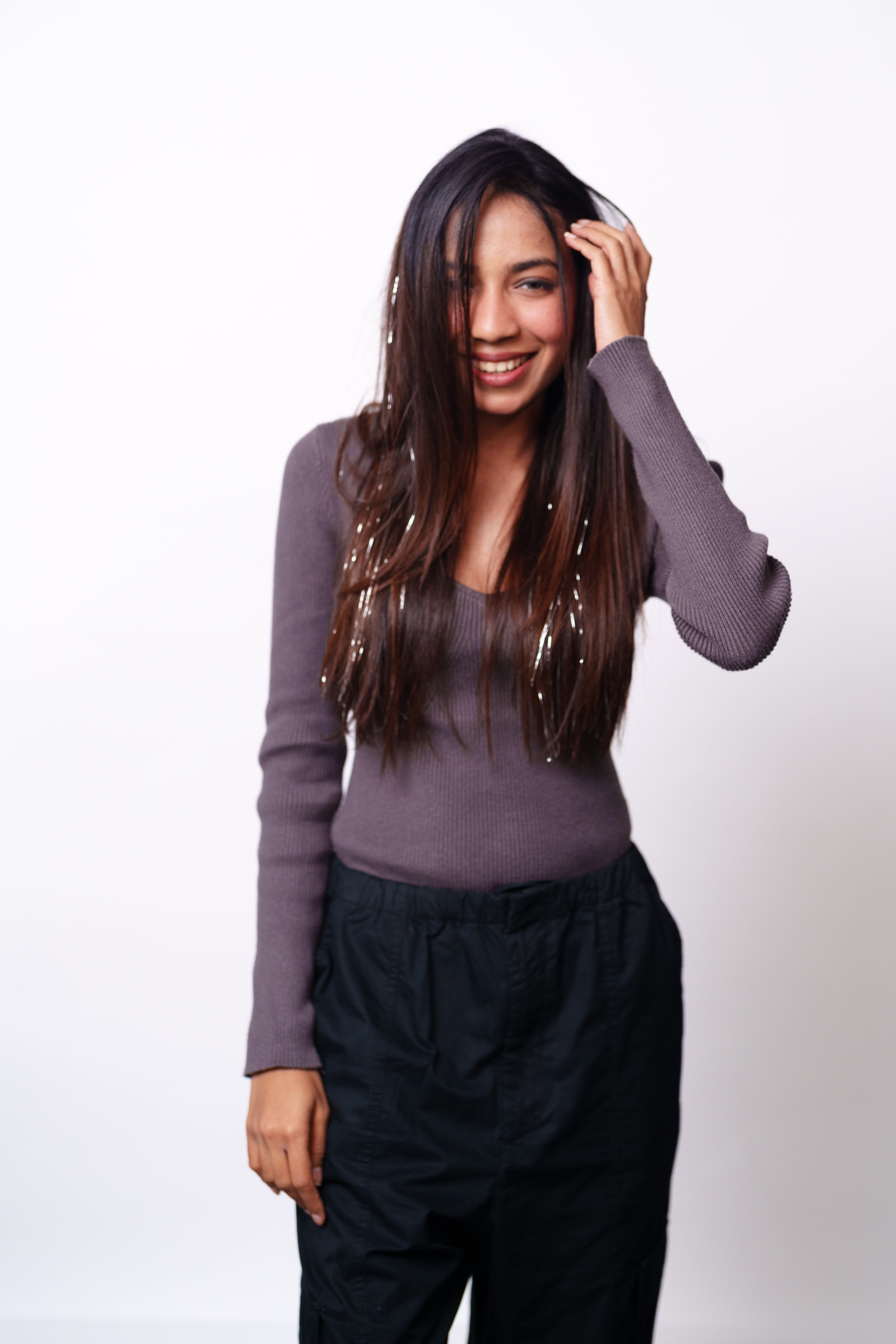 Model Wearing Dolcy Silver Glitter Clip-In Hair Tinsels in Dark Brown Hair – Lifestyle Front View Showing Shimmering Silver Tinsel Strands Blended Through Natural Straight Hair