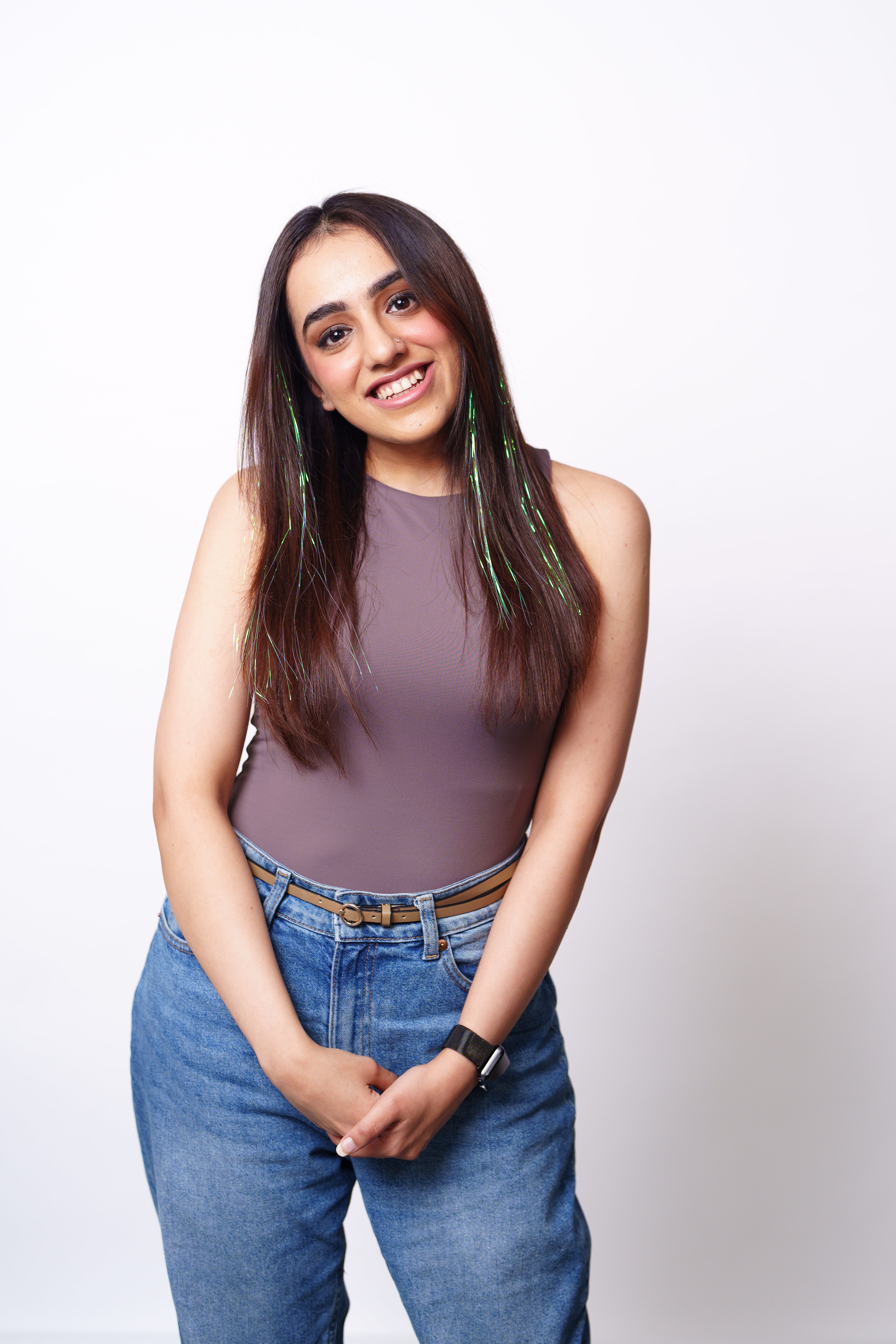 Model Wearing Dolcy Unicorn Curly Glitter Clip-In Hair Tinsels – Front Lifestyle View Showing Iridescent Multicolour Curly Glitter Strands Blended Through Natural Dark Hair