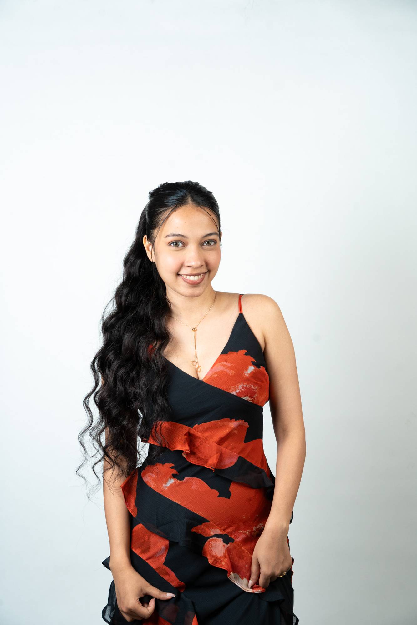 Model Wearing Dolcy Wavy Ponytail Hair Extension in Jet Black – Front View Showing Full-Length Voluminous Waves Draped to One Side with Seamless Natural Blend